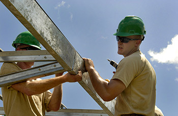 workers with hard hats framing a structure