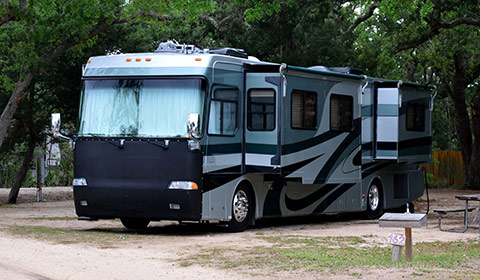 recreational vehicle ( R V ) parked at camp site